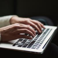 A person typing on a laptop